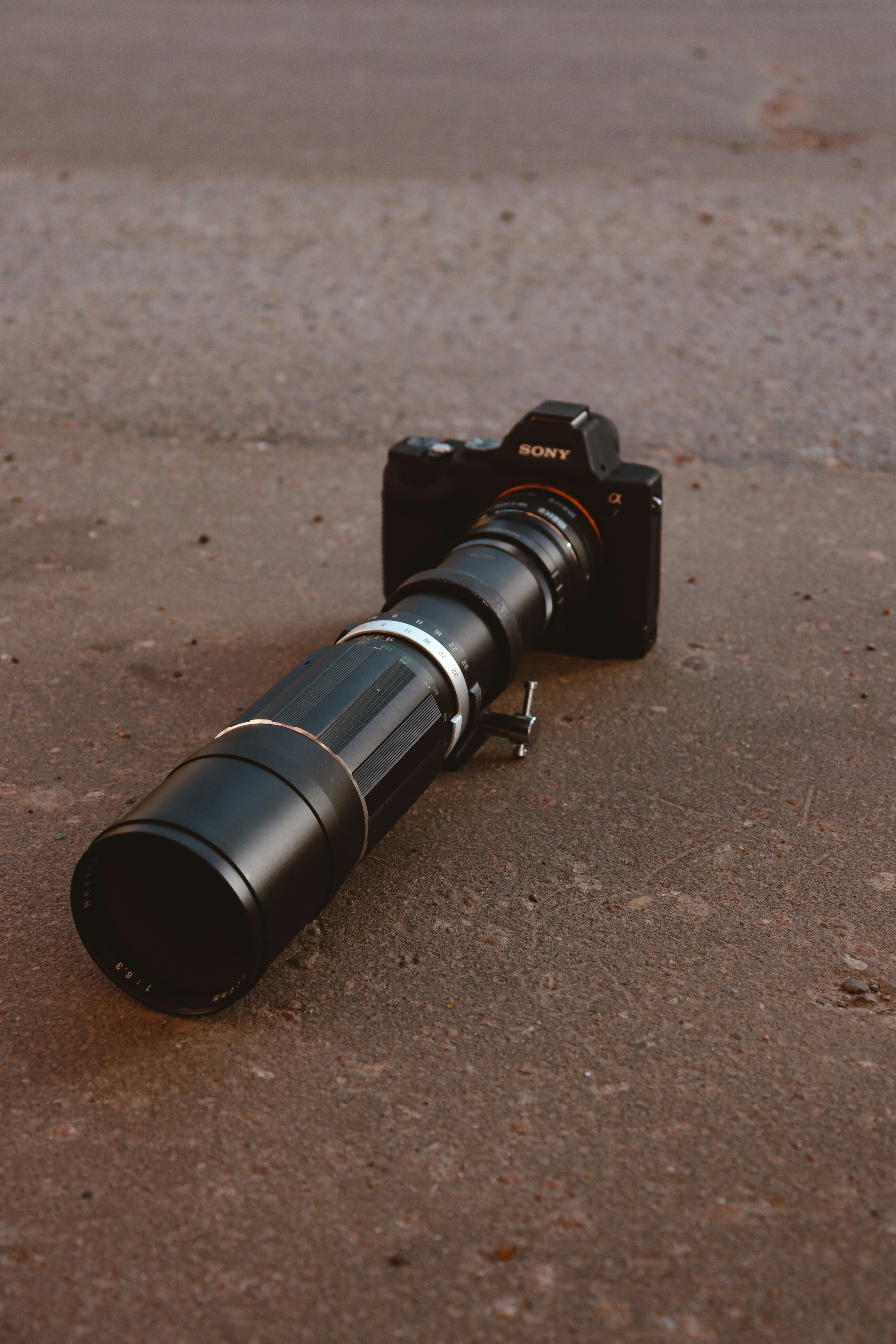 black dslr camera on brown soil